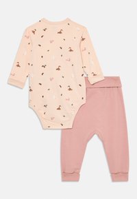 Peach long-sleeve baby bodysuit with animal and leaf prints paired with plain dusty pink baby pants with cuffs.