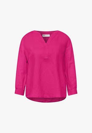 Jasnoróżowa bluzka z długim rękawem, dekoltem w serek, mankietami na rękawach i lekko zaokrąglonym dołem, wykonana z lekkiego materiału.