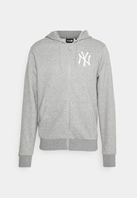 Sudadera gris con cremallera y logo blanco de NY. Está hecha de un tejido suave, cuenta con un bolsillo tipo canguro en la parte frontal y puños y dobladillo acanalados.