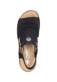 Czarne sandały z teksturowaną cholewką, otwartym wzorem i metalowym dekoracyjnym guzikiem. Wygodna beżowa wkładka, teksturowana brązowa podeszwa.