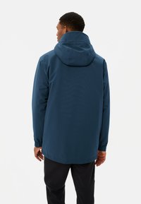 Giacca blu con cappuccio, dotata di polsini e orlo elastici. Texture liscia, materiale resistente all'acqua. Progettata per l'abbigliamento sportivo con una vestibilità comoda.