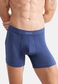 Marineblaue SLOGGI-Boxershorts aus glattem Stoff, mit einem elastischen Bund in mittlerer Höhe, der das Markenlogo trägt, und einer figurbetonten Passform.