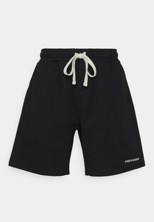 Zwarte knielange shorts met een witte taillekoorden en een klein "PEGADOR" logo op het onderste rechterbeen.