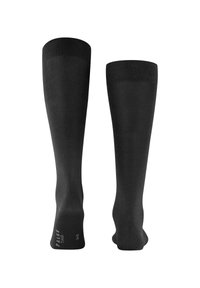 Calze nere alte fino al ginocchio realizzate in materiale liscio con un design aderente. Presentano un tallone e una punta rinforzati, con un marchio sulla suola.