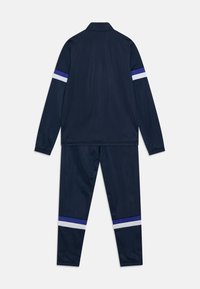 Puma INDIVIDUALRISE TRACKSUIT UNISEX SET - Pantalones deportivos - club navy/lapis lazuli