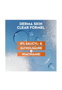 Clear blue background featuring water droplets and white powder, with bold orange text listing ingredients: 8% salicylic acid, glycolic acid, niacinamide.