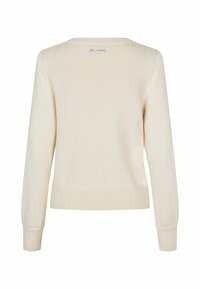 Pull en maille couleur crème avec manches longues et poignets, ourlet et encolure côtelés, vu de dos avec un petit texte bleu près du col.