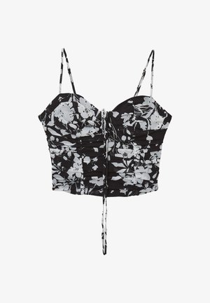 Top cropped floral noir et blanc avec fines bretelles ajustables, texture froncée et détail à cordon sur le devant.