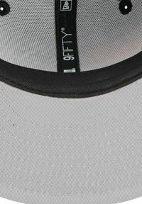 Graue Kappe mit schwarzer Krempe, aus strukturiertem Stoff, mit Innenlabel und kontrastierenden Nahtlinien am Rand.