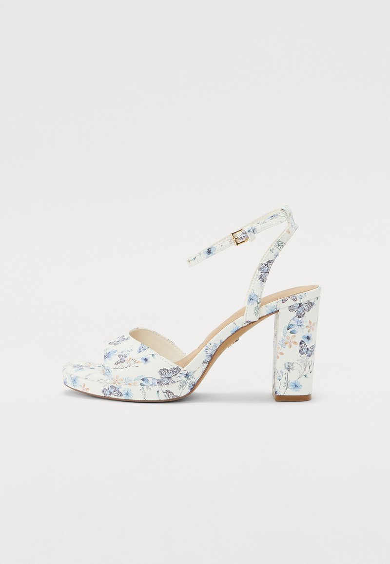 White floral print high-heeled sandal with a thick block heel, ankle strap, and open toe design. Features various blue and peach flowers.