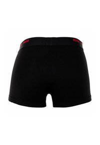 Black boxer shorts with a comfortable fit, featuring a soft waistband labeled "HUGO" in red. Smooth cotton material with minimal seams.
