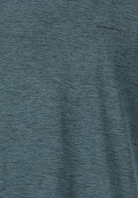 Tumman teallin värinen lyhythihainen urheilupaita, joka on valmistettu rakenteellisesta, kosteutta siirtävästä kankaasta; siinä on pieni "ENDURANCE"-logo mustana.