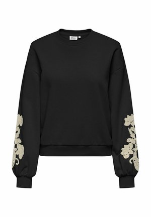 Sweat-shirt noir avec des manches longues et bouffantes. Présente une broderie florale beige au niveau des poignets. Le tissu semble doux avec une coupe décontractée.