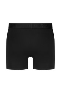 Boxers noirs en tissu lisse et extensible. Présentent un design sans couture et une taille douce à logo.