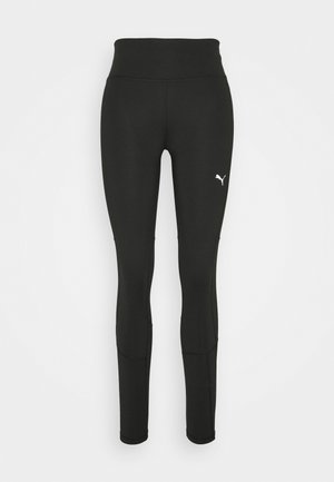 Leggings neri con vita alta, realizzati in tessuto elasticizzato. Presentano cuciture piatte e unlogo bianco sul lato destro della gamba.