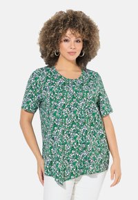 Maglietta a maniche corte con stampa floreale verde e scollo rotondo, realizzata in tessuto leggero, con una vestibilità ampia e orlo arrotondato.