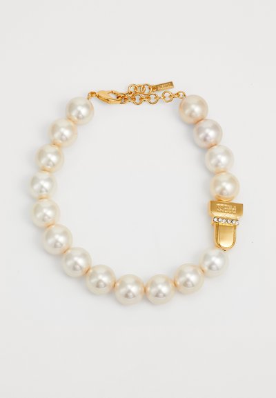 Pearl necklace with round, lustrous cream pearls, featuring a gold clasp with rhinestone accents. Textured finish adds elegance.