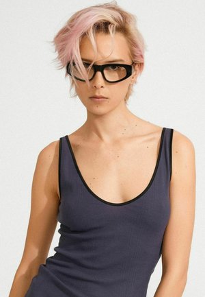 Black-rimmed glasses worn with a dark gray ribbed tank top featuring a deep scoop neckline and thin black edging. Smooth texture.