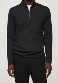 Suéter negro con cremallera, cuello alto, mangas largas y diseño ajustado. Hecho de un tejido de punto liso.