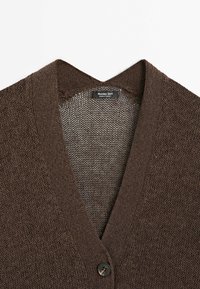Brown knitted V-neck cardigan with button closure and a Massimo Dutti label at the collar, laid flat on a white background.