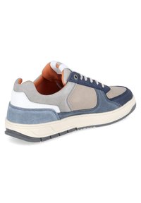 Casual sneaker with blue, gray, beige, and white panels, orange interior lining, white laces, and a gray rubber sole, shown from a rear side angle.