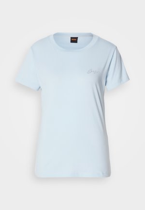 Light blue cotton t-shirt with short sleeves, rounded neckline, and a small, embroidered logo on the left chest. Smooth texture.