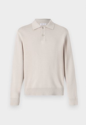 Lys beige langærmet polo skjorte lavet af blødt materiale. Har krave, tre-knaps lukning og ribbede manchetter og kant.