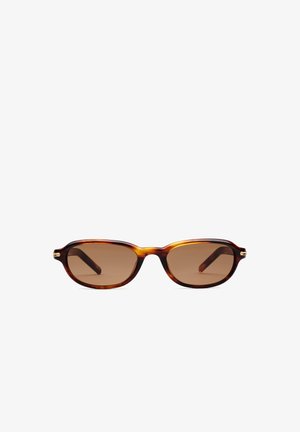 Lunettes de soleil ovales en écaille avec verres teintés marron et montures fines, présentées sur un fond blanc uni.