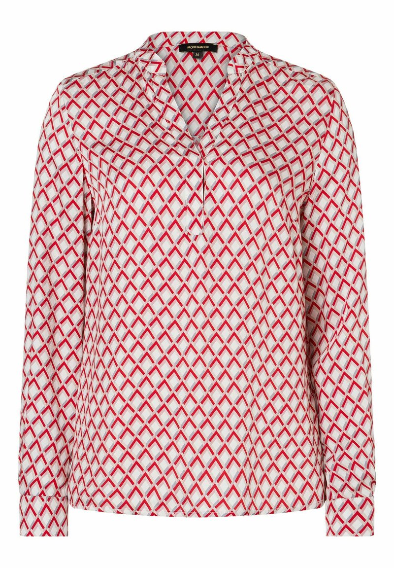 Long-sleeve blouse in white fabric featuring a geometric red pattern. Notable details include a pointed collar and buttoned cuffs.