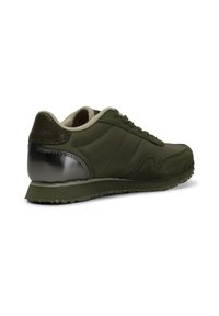 Zapatillas de deporte verde oliva con una combinación de texturas suaves y de ante, con un acento metálico en el talón, cuello acolchado y suela texturizada.