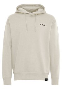 Light beige hoodie made of soft fabric, featuring a kangaroo pocket, drawstring hood, and black "A.R.C." text on the chest.
