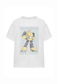 White T-shirt featuring a graphic of a yellow Transformer character, with “TRANSFORMERS” text in light gray behind it. Short sleeves, cotton material.