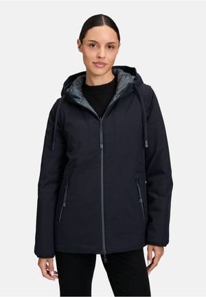 Veste à capuche navy avec une fermeture éclair sur le devant, dotée d'un intérieur gris matelassé, de poignets élastiques et de deux poches latérales zippées.