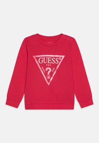 Röd sweatshirt i bomull med en stor vit triangel-logotyp med texten "GUESS U.S.A." och en frågetecken-design. Inkluderar tryckknappar.