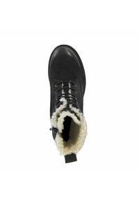 Zwarte leren enkellaarzen met een nepbontvoering, ronde neus en witte veters. De binnenkant is gevoerd met zacht, fluffy materiaal.