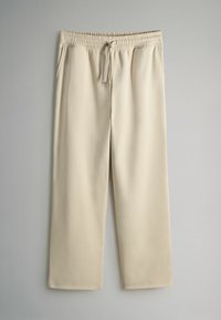 Beige, weite Stretchhosen mit elastischem Bund, Kordelzug und glatter, weicher Textur. Keine Taschen oder Muster.