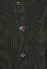 Cardigan en maille vert foncé avec un décolleté en V et quatre grands boutons ronds à finition mate, design côtelé texturé sur l'ensemble.