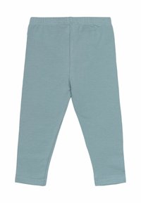 Lichtblauwe legging gemaakt van zachte katoen met een elastische tailleband. Bevat een gladde textuur en taps toelopende beenopeningen.