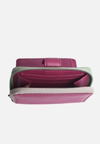 Pink leather wallet with a stitched design, featuring multiple card slots and a zippered compartment, outlined by a contrasting green trim.