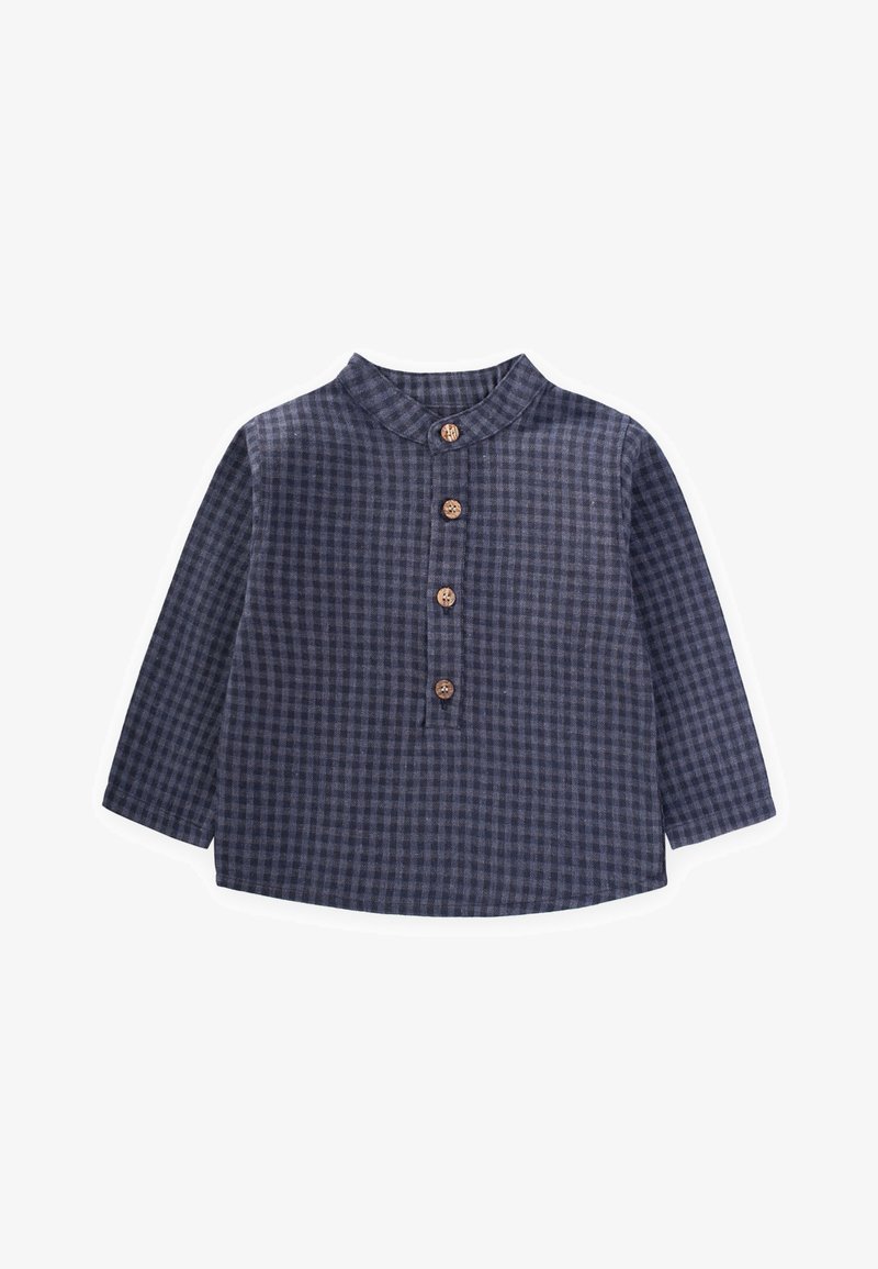 Tums zilgas šaura joslu krekls ar garām piedurknēm, koka pogām un stāvu apkakli, izgatavots no struktūras auduma.