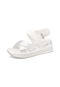 Sandali bianchi con cinturino incrociato argento, cinturino alla caviglia regolabile e una spessa suola bianca ammortizzata con linee orizzontali scolpite.