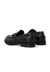 Schwarze Leder Slipper mit runder Zehenform, niedrigem Absatz und strukturierten Seitenverzierungen. Verfügen über gestickte Akzente und eine Gummisohle für besseren Grip.