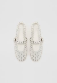 White Mary Jane shoes made of transparent material, featuring a decorative strap with metal studs and rhinestones. Rounded toe design.