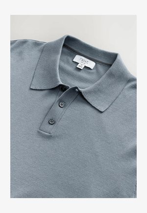 Gray polo shirt made of knit material featuring a collar, three button placket, and subtle texture; tag indicates brand "next."