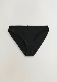 Dámske čierne spodné prádlo v štýle bikiniek s malou ozdobnou mašľou v strede vpredu, položené na bielom povrchu.