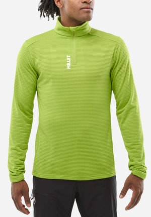 Pull-over vert à manches longues avec un col haut, tissu texturé présentant de fines rayures horizontales et une fermeture éclair à l'avant. Logo de la marque sur la poitrine.