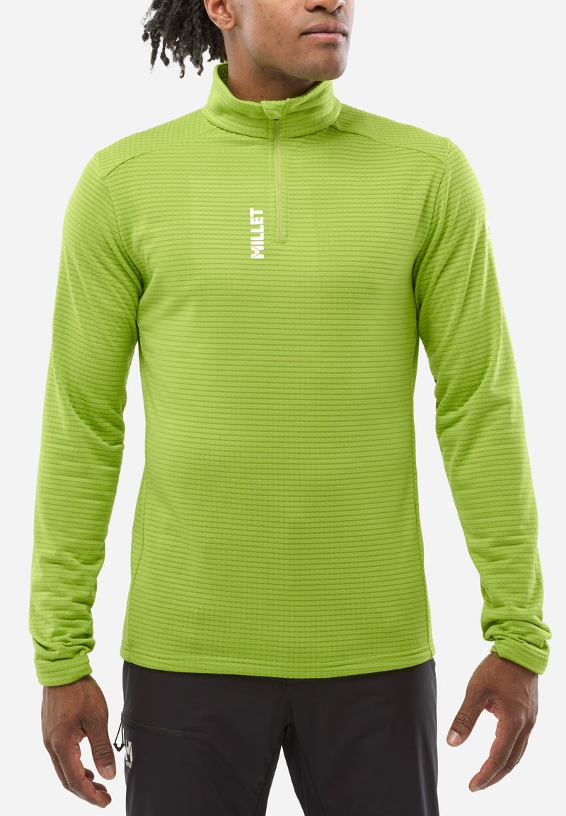 Pull-over vert à manches longues avec un col haut, tissu texturé présentant de fines rayures horizontales et une fermeture éclair à l'avant. Logo de la marque sur la poitrine.