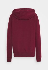 Maroon hooded sweatshirt with long sleeves, ribbed cuffs, and waistband. Smooth texture and simple design, featuring a large hood.