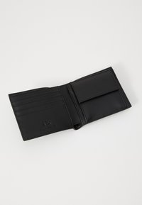 Black leather wallet, bi-fold design, featuring multiple card slots, a coin pocket, and embossed logo detail on interior. Smooth texture.