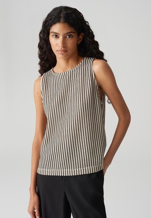 Sleeveless knitted top with a vertical black and white pattern, round neckline, and side slits. Fabric appears textured and lightweight.